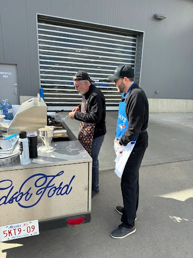 Cooking up burgers on the Windsor Ford BBQ cart at a community event