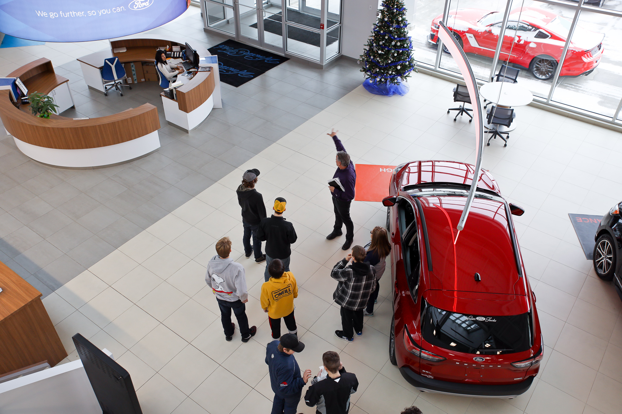 A Windsor Ford team member leading a group tour through the showroom