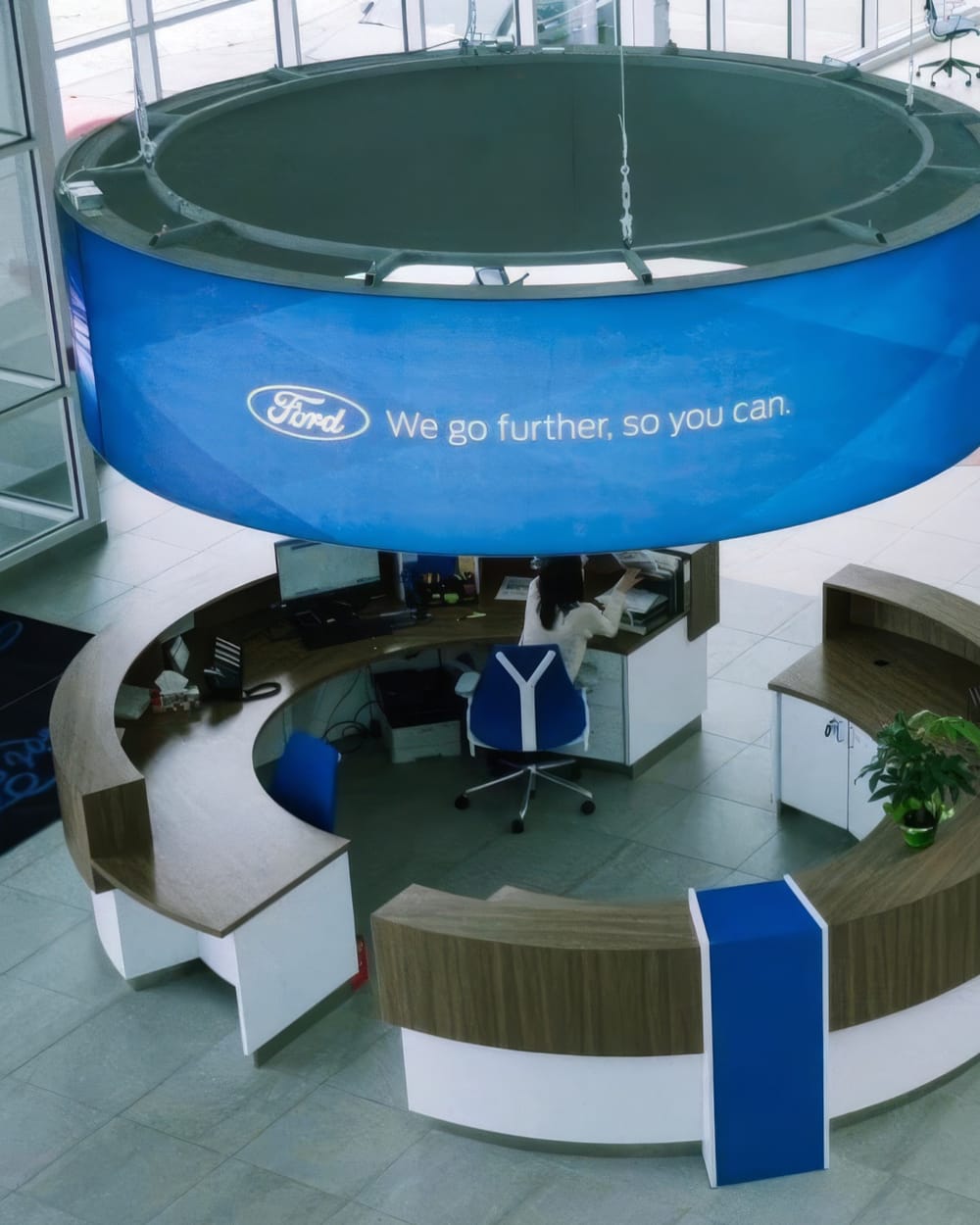 The reception desk inside the Windsor Ford showroom, staffed and taking calls