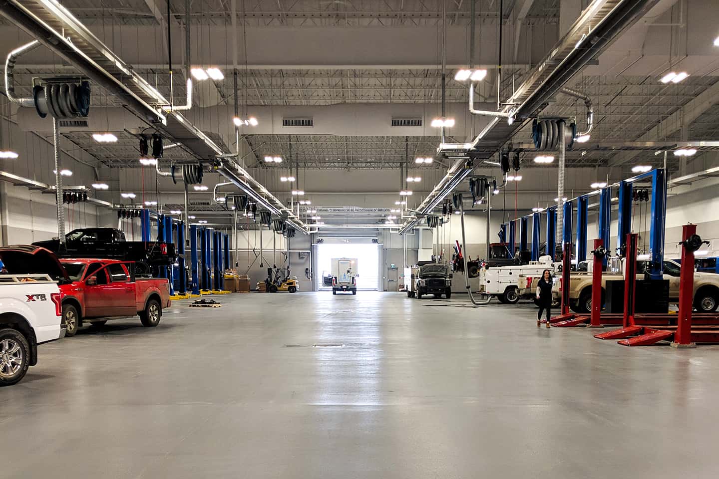 The Windsor Ford service shop in Grande Prairie, a wide view down the rows of service bays and vehicle hoists